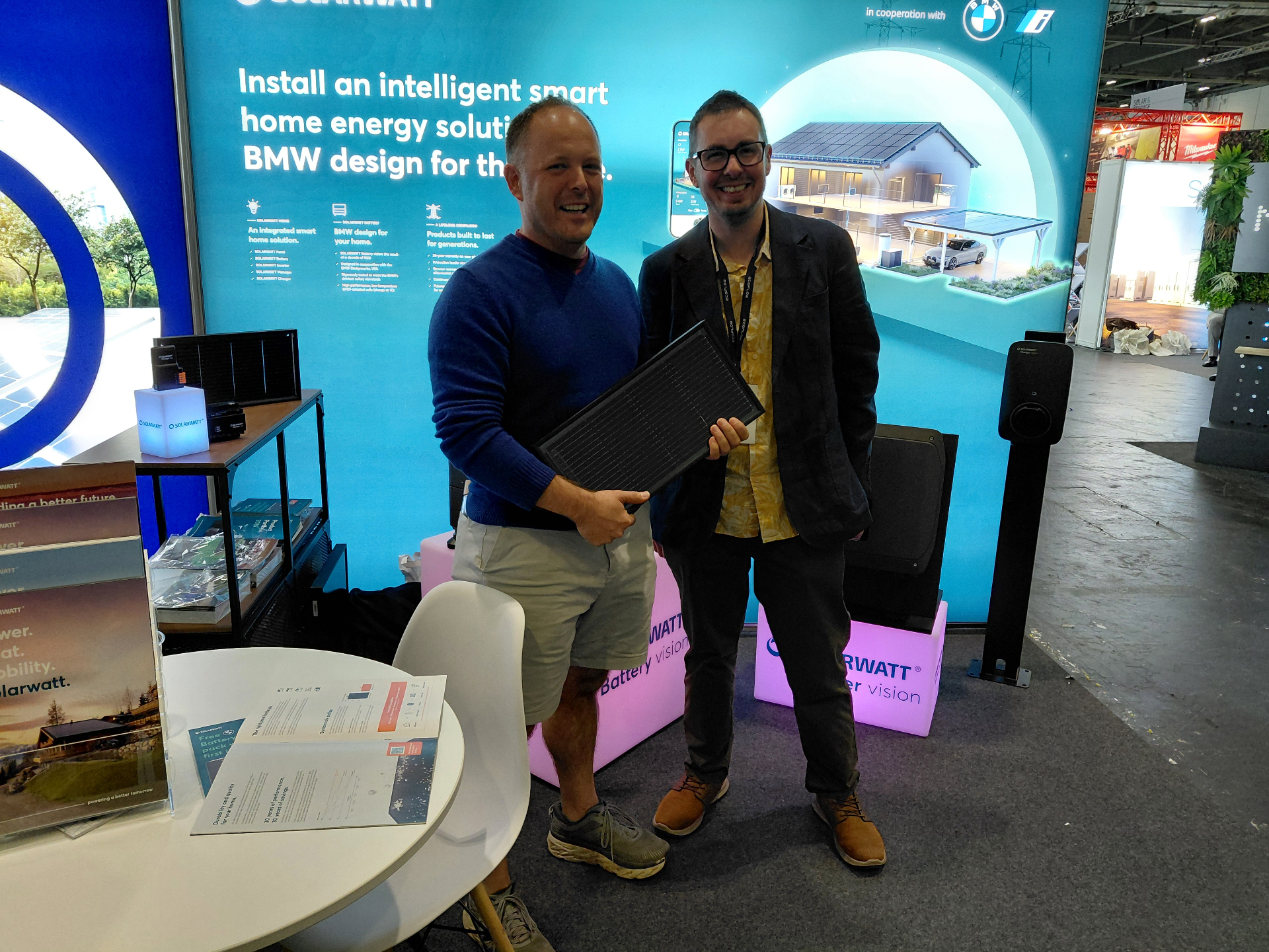 Tom (left) and Chris at the Solarwatt stand, inspecting a glass-glass solar module.